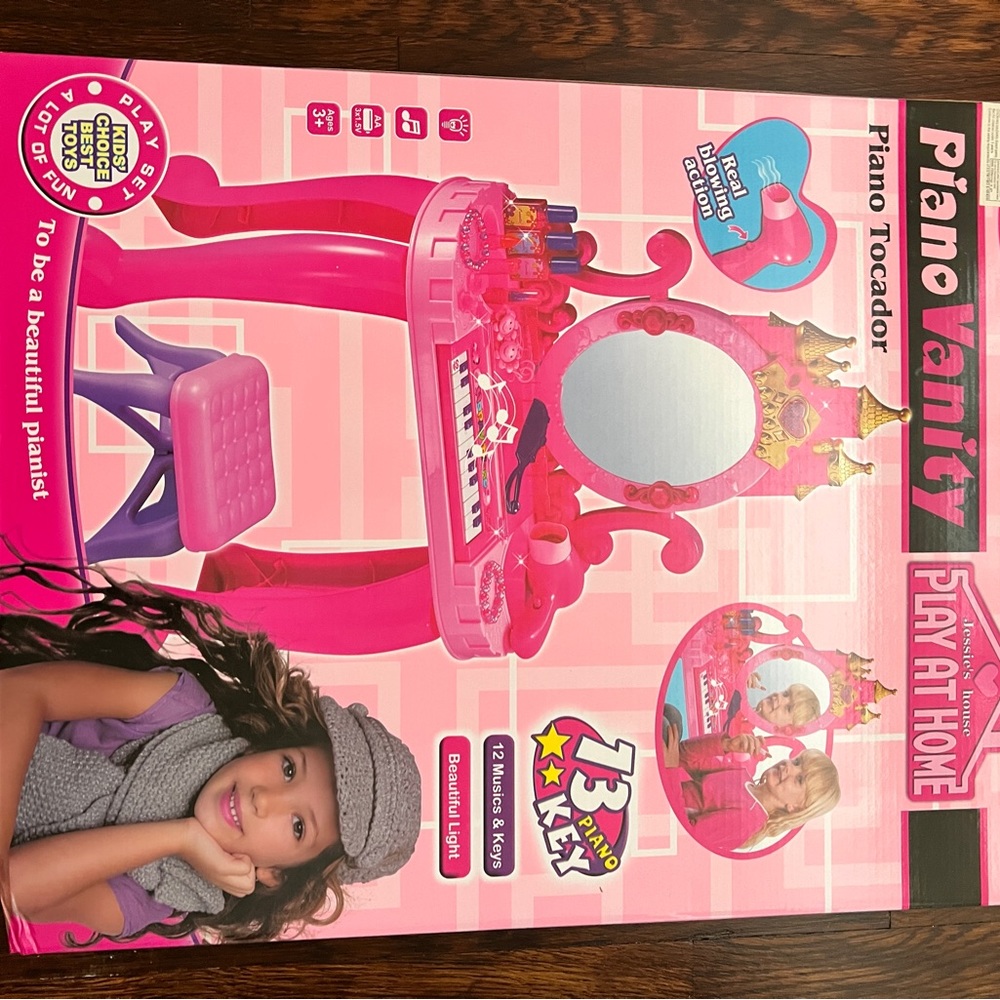 Brand new in box. Never opened. Kids piano vanity set.